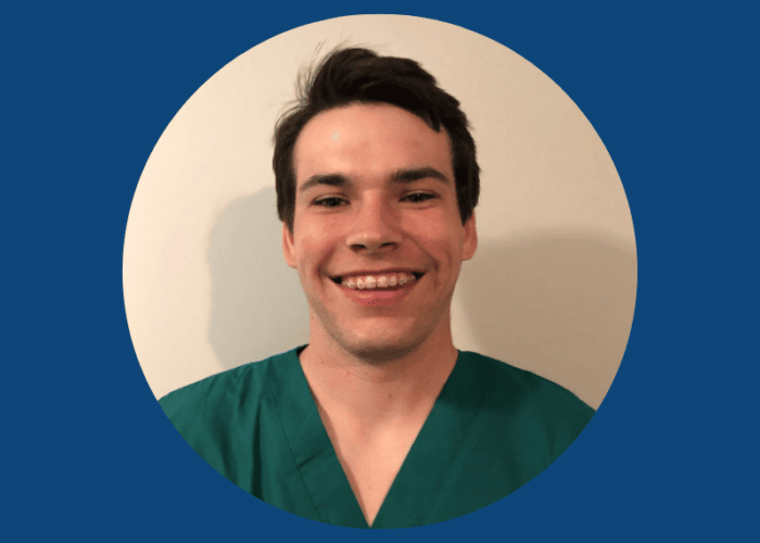 A person wearing green scrubs, representing Minnesota Hospitals, smiles at the camera against a plain background, framed by a circular blue border.