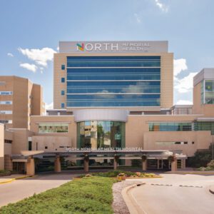 Exterior view of North Memorial Health hospital building on a sunny day, showcasing modern architecture under a clear blue sky. As one of the leading Minnesota Hospitals, it stands as a beacon of care and expertise.